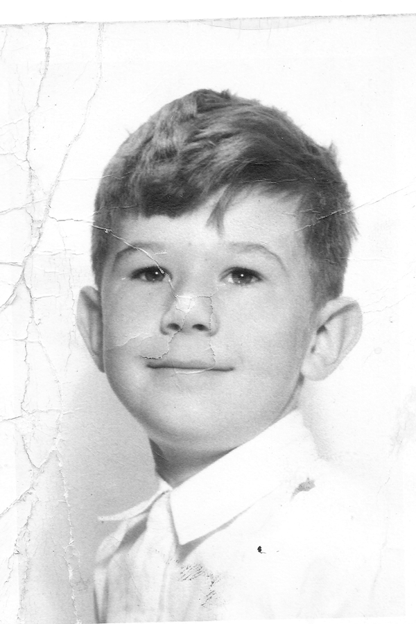 Original childhood portrait showing cracks and tears