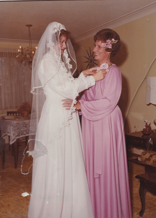 Original faded wedding photograph of a bride and older woman